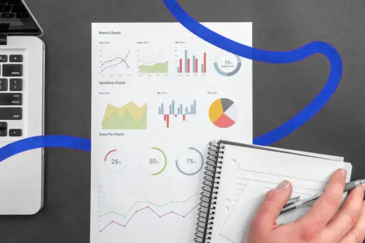 Printed analytics charts next to a notebook