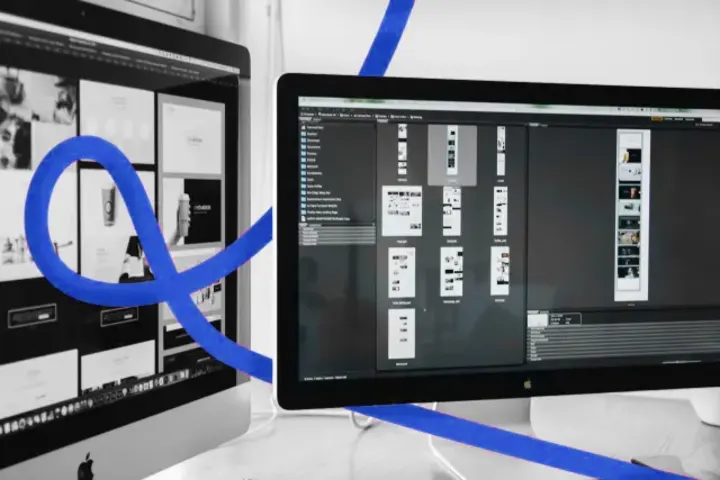 Website page layouts open on two desktop screens
